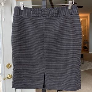 Woman’s checkered black and white skirt with hot pink silk inside